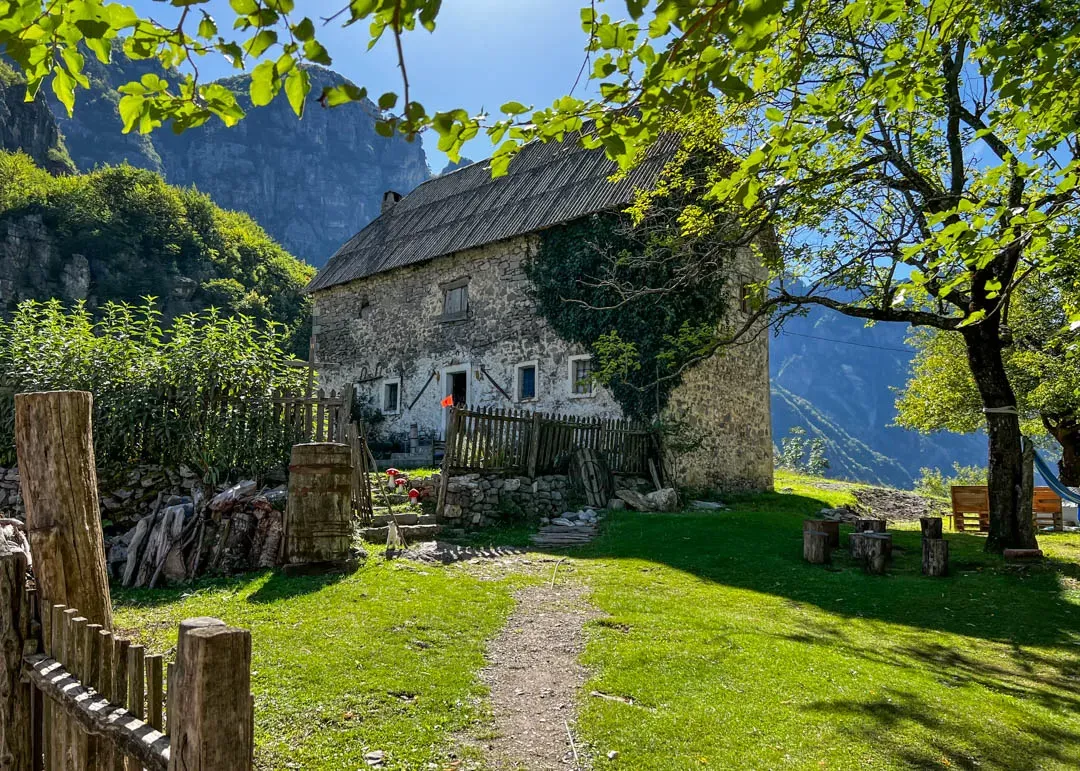 Një shtëpi tradicionale guri në Luginën e Thethit, Alpet Shqiptare, duke simbolizuar agroturizmin dhe jetën rurale.